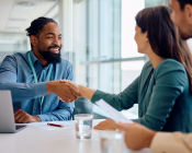 Couple meeting adviser and shaking hands