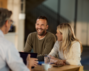 Couple smiling as the meet with an adviser